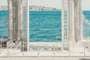 ornamental-white-gate-against-sea-backdrop
